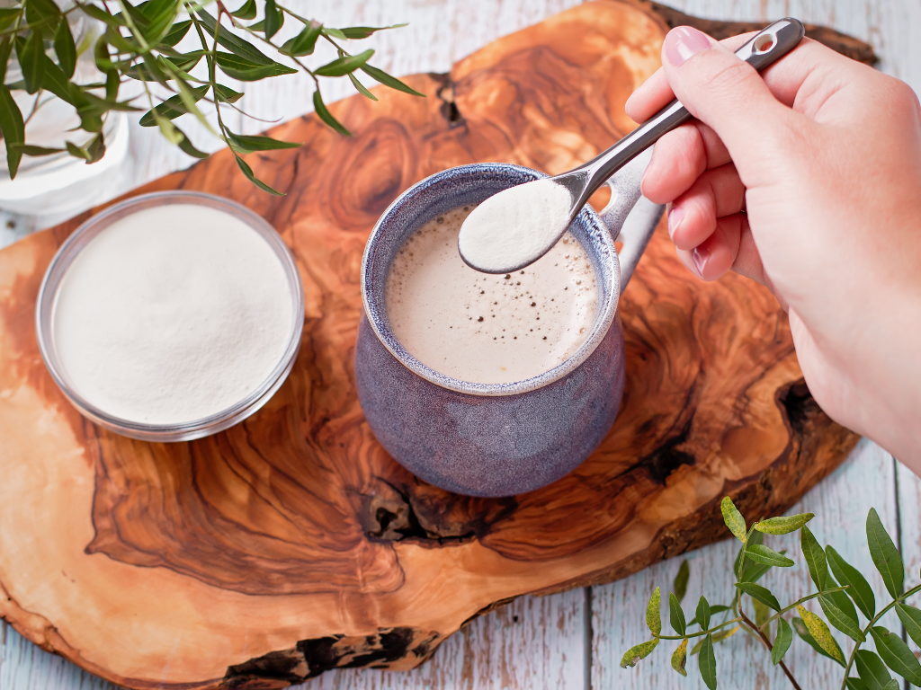 Photo of adding protein supplement powder into a beverage.