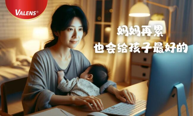 mother holding sleeping baby in front of the computer