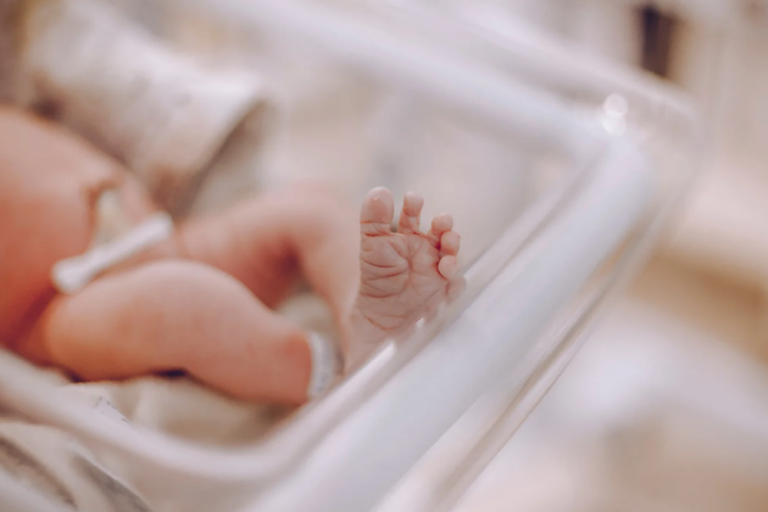 Newborn Baby Sleeping In A Crib
